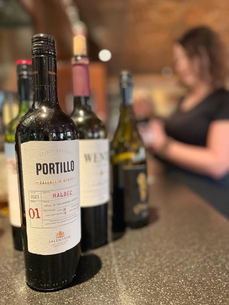 Wine bottles and woman in background