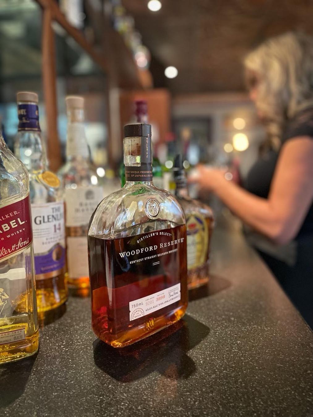 Bartender and whisky bottle
